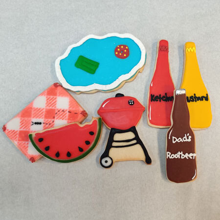 Summer cookies of a barbeque, condiment bottles, watermelon, blue cloud and root beer bottle for Lemon Drop Cookie Shop.