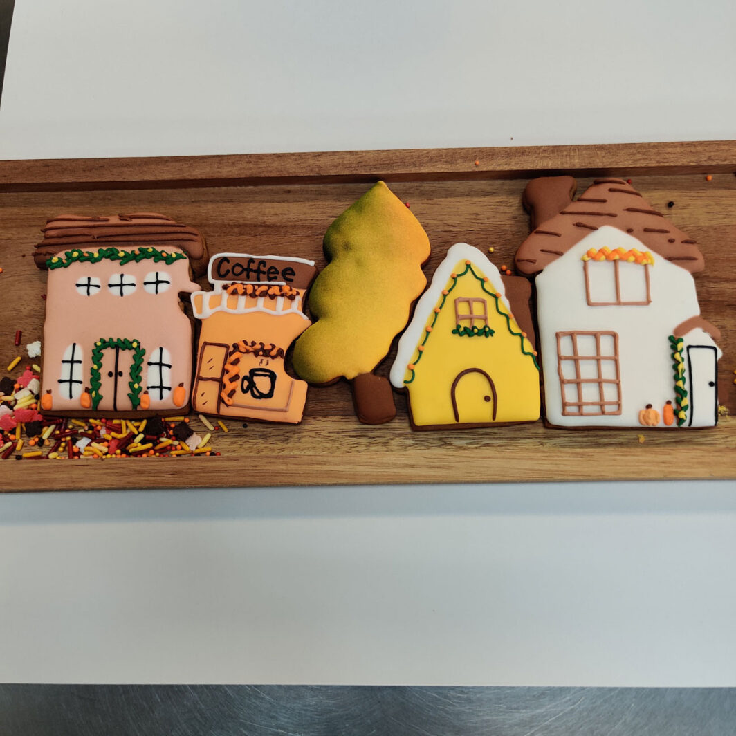 Gingerbread fall village cookies frosted and decorated with fall theme.