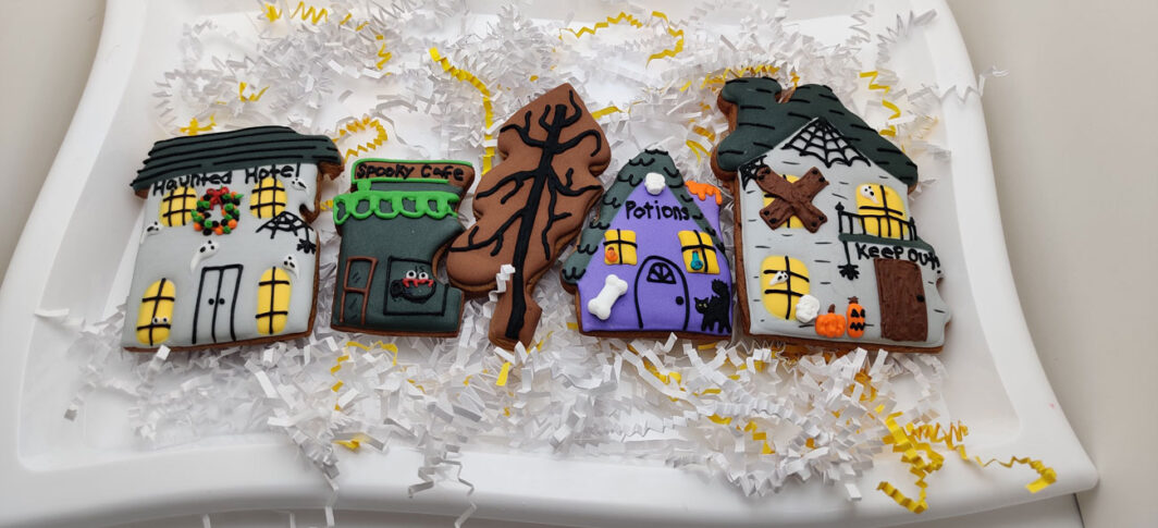 Gingerbread haunted village cookies decorated.